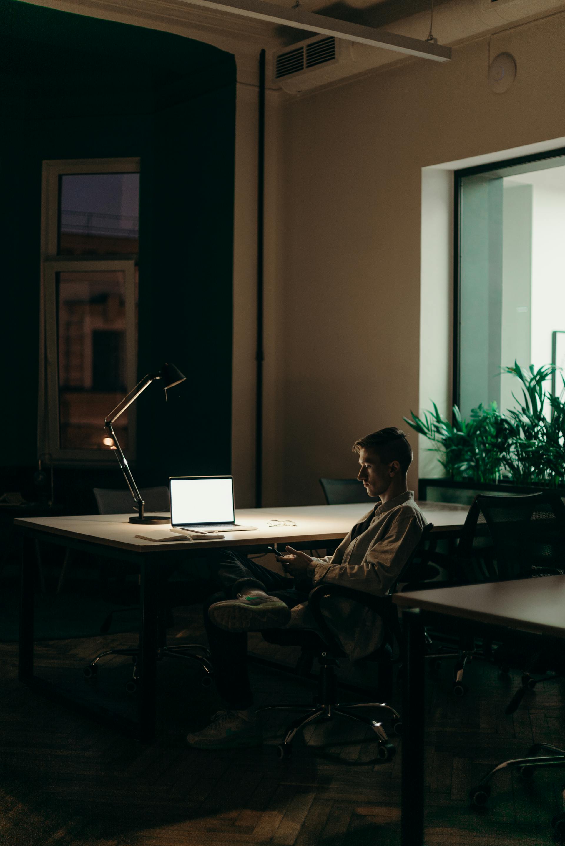 Professional working late at desk — focused procurement analysis